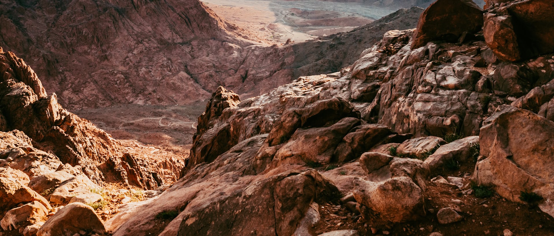 Granite peaks of the Sinai interior at first light, viewed from the trail above the monastery
